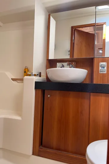  Yacht Photos Pics Interior of 2017 Hanse 455 yacht bathroom with wooden cabinetry and modern sink.