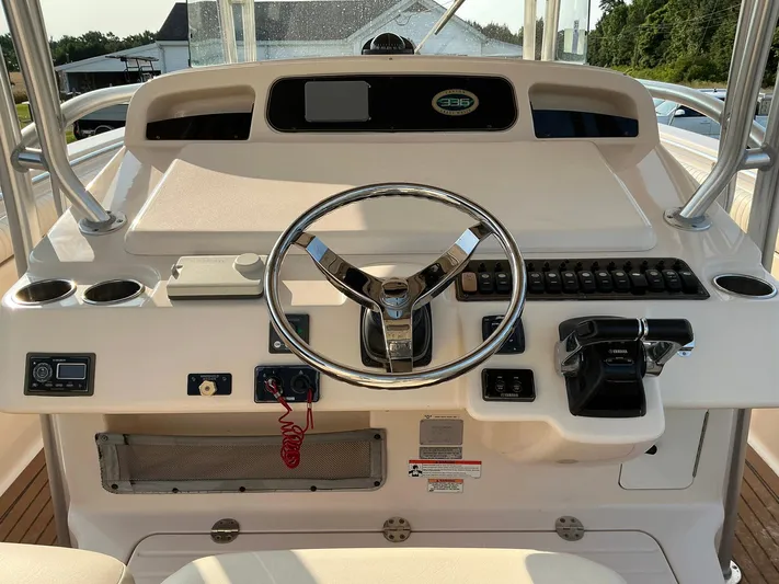 H Lady Frances Yacht Photos Pics Helm of 2011 Grady-White Canyon 336 boat with steering wheel and controls.