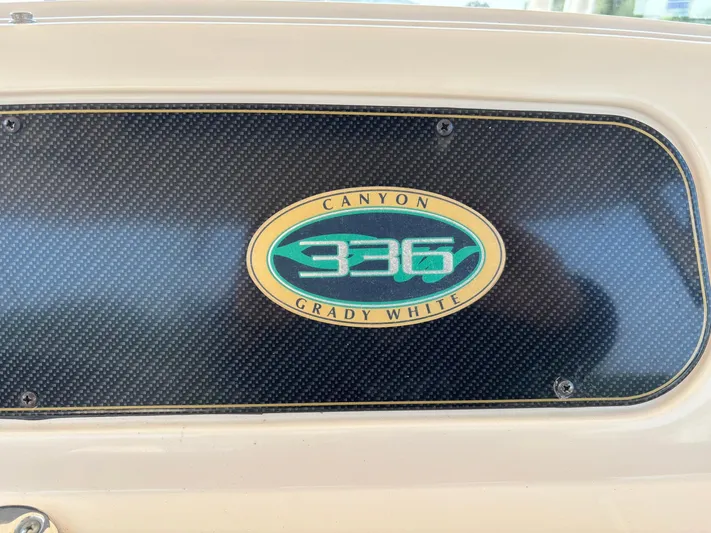H Lady Frances Yacht Photos Pics 2011 Grady-White Canyon 336 boat emblem on carbon fiber background.