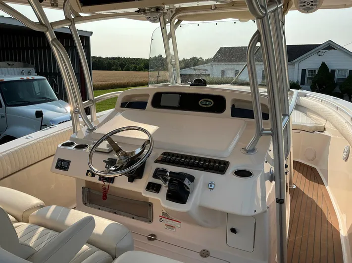 H Lady Frances Yacht Photos Pics 2011 Grady-White Canyon 336 boat cockpit with steering wheel and controls.