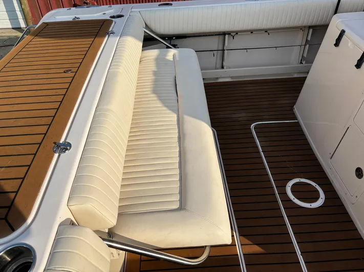 H Lady Frances Yacht Photos Pics 2011 Grady-White Canyon 336 boat interior with cushioned seating and wooden deck.