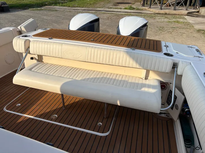 H Lady Frances Yacht Photos Pics 2011 Grady-White Canyon 336 boat with cushioned seating and wooden deck.