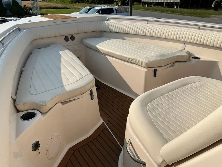 H Lady Frances Yacht Photos Pics 2011 Grady-White Canyon 336 boat interior with cushioned seating and wood-style flooring.