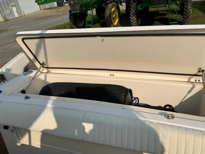 H Lady Frances Yacht Photos Pics Open storage compartment on a 2011 Grady-White Canyon 336 boat, with shadows and machinery in background.