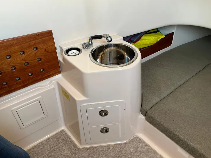 H Lady Frances Yacht Photos Pics 2011 Grady-White Canyon 336 interior with sink, storage drawers, and cushioned seating.