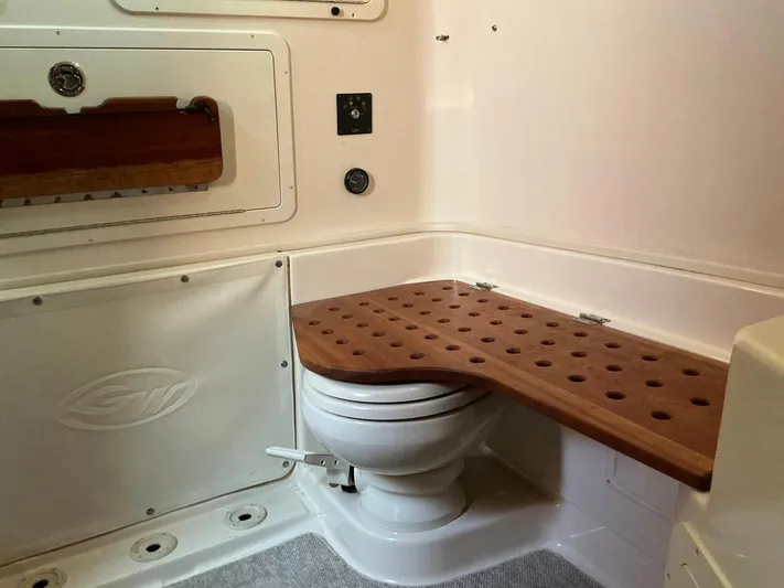 H Lady Frances Yacht Photos Pics 2011 Grady-White Canyon 336 boat bathroom with wooden bench and toilet.