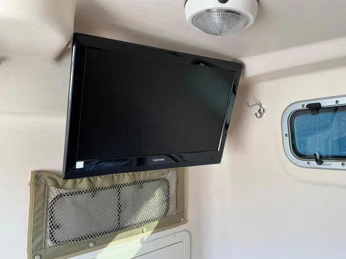H Lady Frances Yacht Photos Pics Flat-screen TV inside 2011 Grady-White Canyon 336 boat cabin.