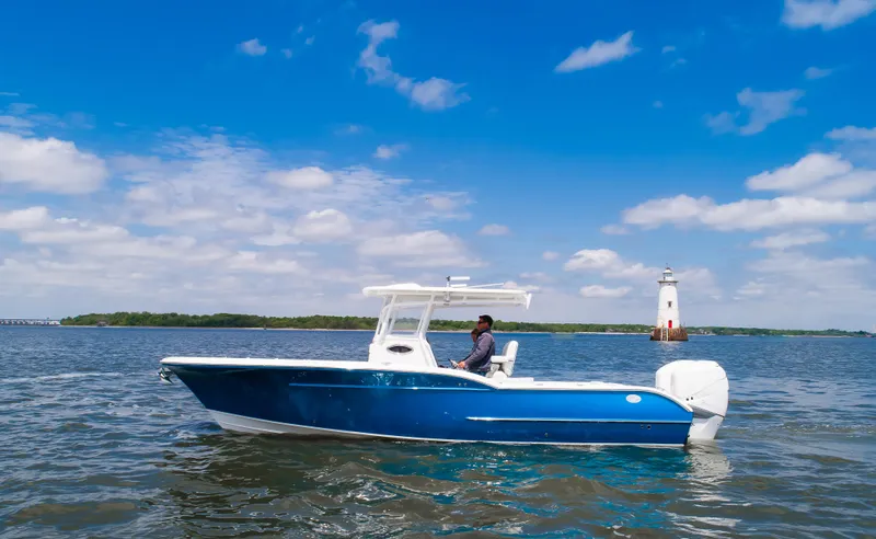  Yacht Photos Pics 2025 Buddy Davis 28 Center Console boat on open water, clear sky background.