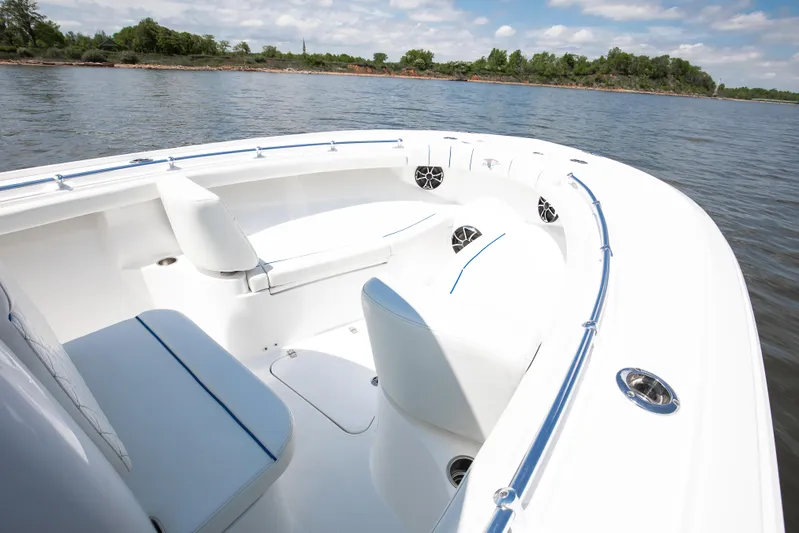  Yacht Photos Pics 2025 Buddy Davis 28 Center Console boat on calm water, featuring sleek seating and modern design.