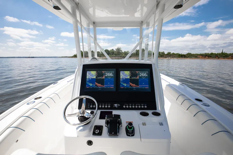  Yacht Photos Pics 2025 Buddy Davis 28 Center Console boat dashboard with dual navigation screens on open water.