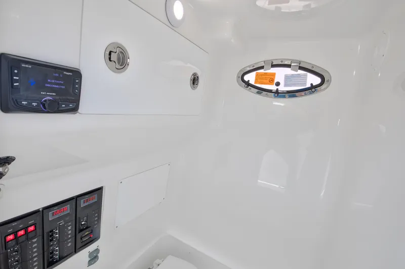 Yacht Photos Pics Interior of 2025 Buddy Davis 28 Center Console boat, featuring control panels and porthole.