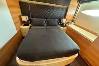 Luxurious bedroom with black bedding in 2011 AB 140 yacht interior.