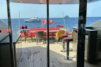 Luxurious yacht deck with seating, ocean view, and nearby boats; AB 140 model, 2011.