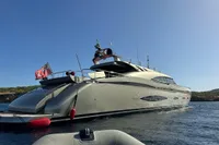 Luxurious AB 140 yacht from 2011 on calm waters, featuring sleek design and flag.