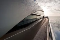 Sleek AB 140 yacht deck, 2011 model, cruising at sunset on open sea.