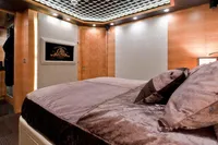 Luxurious bedroom interior in AB 140 model, 2011, featuring plush bedding and modern design.
