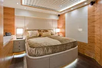 Luxurious yacht bedroom with modern design, featuring wood paneling and ambient lighting. AB 140, 2011.