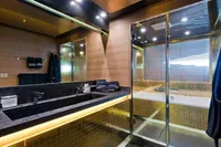 Luxurious modern bathroom with sleek black fixtures and ambient lighting, AB 140 yacht, 2011.