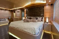 Luxurious bedroom with modern decor, ambient lighting, and elegant wooden finishes.