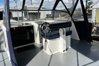 Interior view of a 2002 Custom Belter 1240 boat with steering wheel and seating.