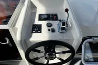 Steering console of 2002 Custom Belter 1240 boat with controls and gauges.