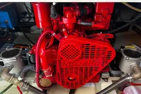 Red engine of Custom Belter 1240, 2002 model, with visible hoses and components.
