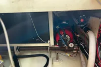Engine compartment of a 2002 Custom Belter 1240 with visible wiring and components.