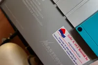 Close-up of a Custom Belter 1240 machine with a company contact label.