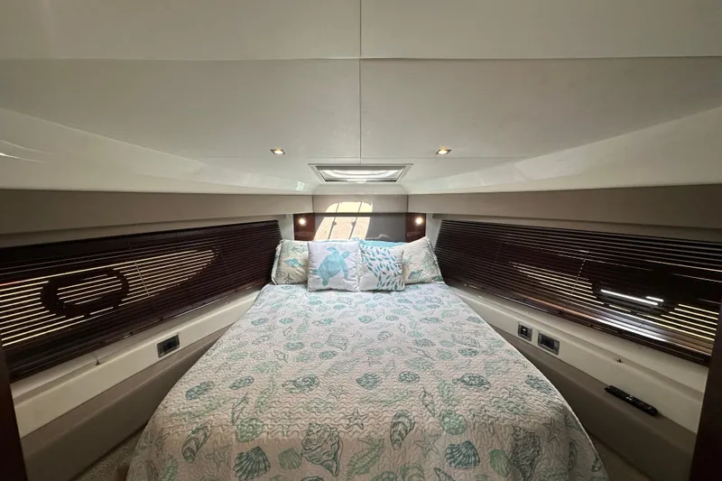  Yacht Photos Pics Luxurious cabin interior of 2017 Sea Ray Fly 460 yacht with elegant bedding and ambient lighting.