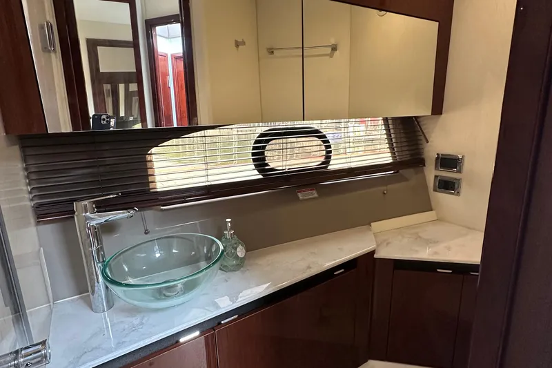  Yacht Photos Pics Luxurious bathroom interior of 2017 Sea Ray Fly 460 yacht with glass sink and modern fixtures.