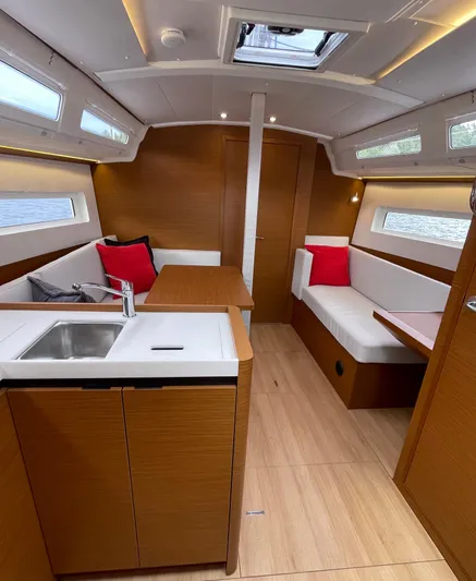  Yacht Photos Pics 2024 Jeanneau Sun Odyssey 380 interior with modern wood finish and cozy seating area.