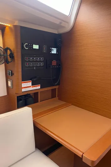  Yacht Photos Pics 2024 Jeanneau Sun Odyssey 380 interior with navigation panel and seating area.