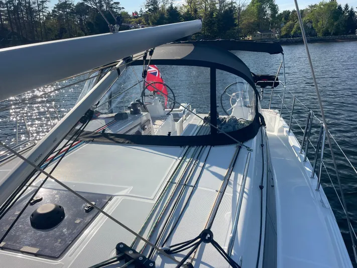  Yacht Photos Pics 2024 Jeanneau Sun Odyssey 380 sailboat on calm water, featuring sleek deck design.