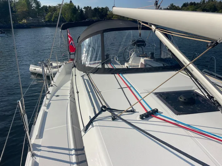  Yacht Photos Pics 2024 Jeanneau Sun Odyssey 380 sailboat on calm water, featuring sleek deck design.