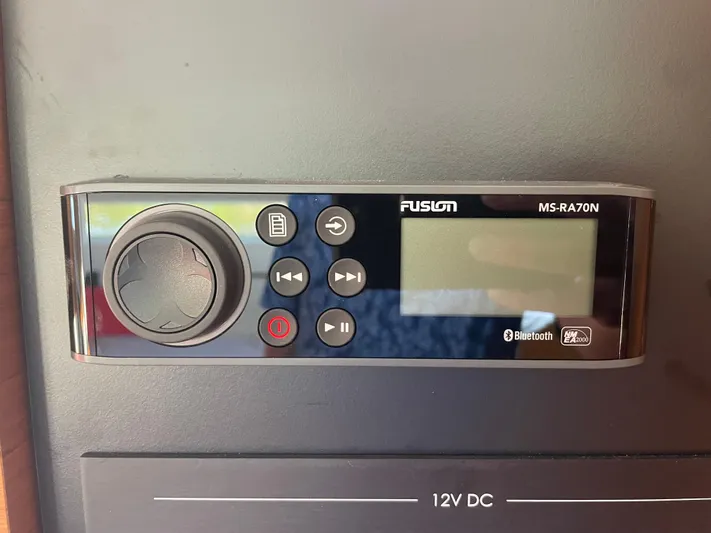  Yacht Photos Pics Fusion MS-RA70N stereo system on Jeanneau Sun Odyssey 380, 2024 model, with Bluetooth connectivity.