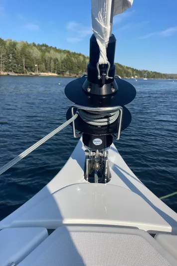  Yacht Photos Pics 2024 Jeanneau Sun Odyssey 380 sailboat bow with forestay and furler on calm water.