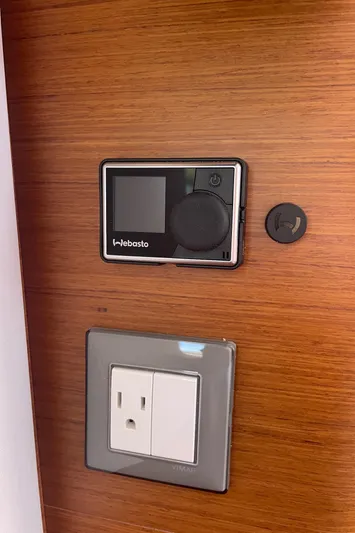  Yacht Photos Pics Thermostat and outlet on Jeanneau Sun Odyssey 380, 2024 model, wooden panel background.