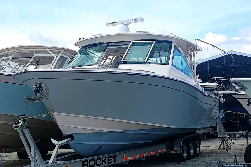 375-712 Used Yacht Photos Pics 2021 Grady-White Freedom 375 boat on trailer, parked outdoors.