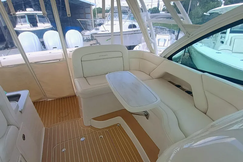 375-712 Used Yacht Photos Pics 2021 Grady-White Freedom 375 boat interior with white seating and wooden flooring.