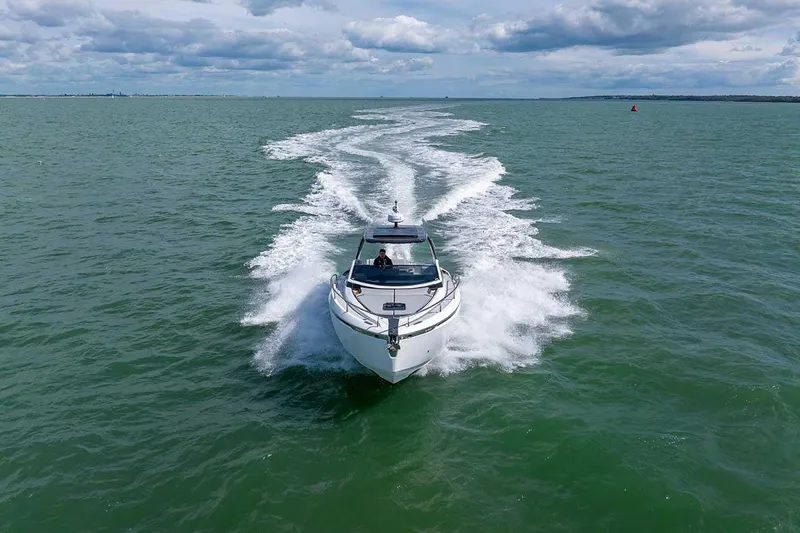  Yacht Photos Pics 2024 Fairline F//Line 33 cruising on open water under a cloudy sky.