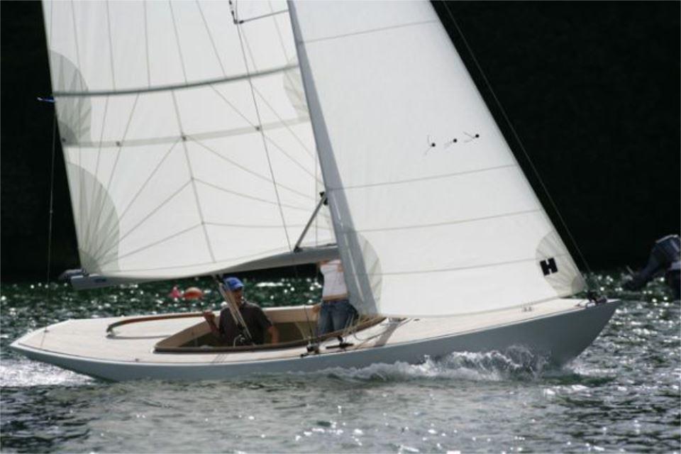 Sailing on water, Rustler 24 yacht, 2025 model, with white sails and crew.