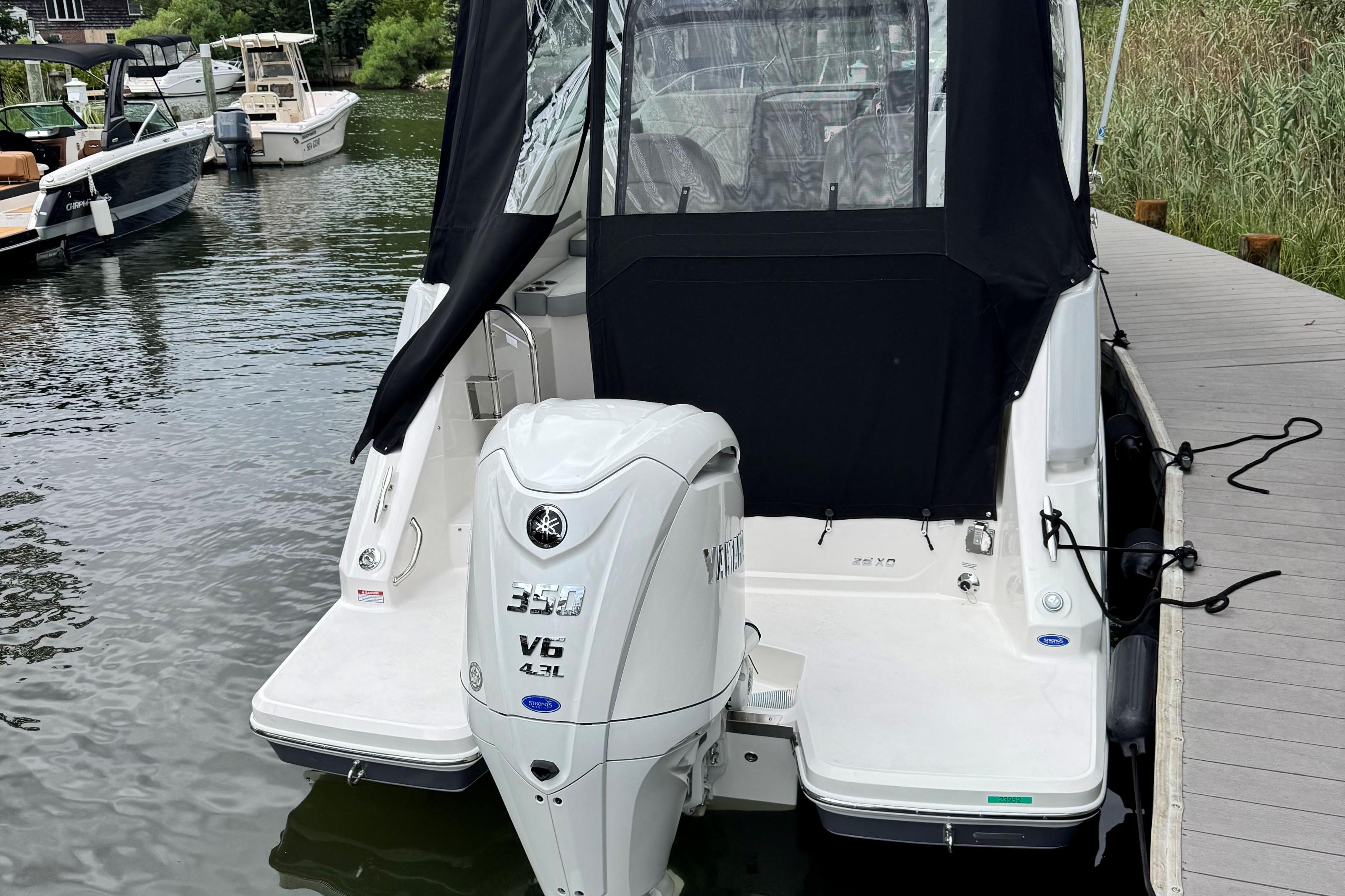 2026 Regal 26 XO boat with Yamaha V6 engine docked at marina.