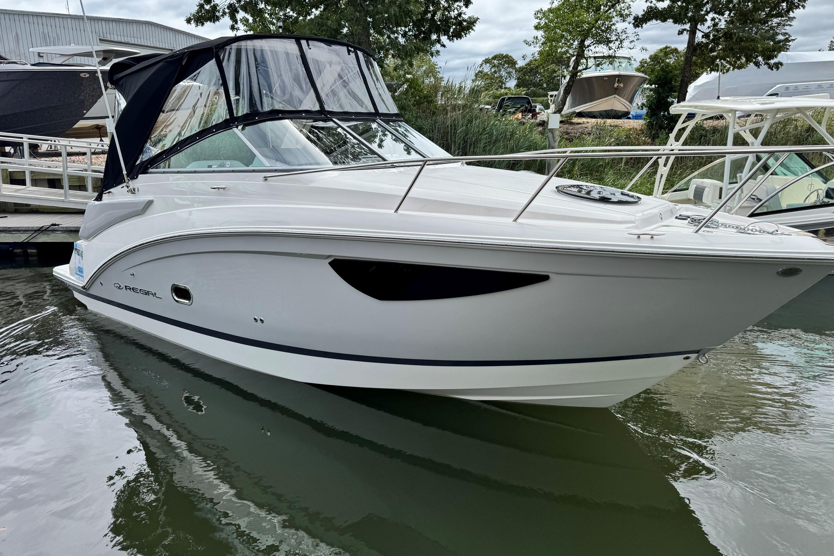 2026 Regal 26 XO boat docked in calm waters, featuring sleek design and modern amenities.