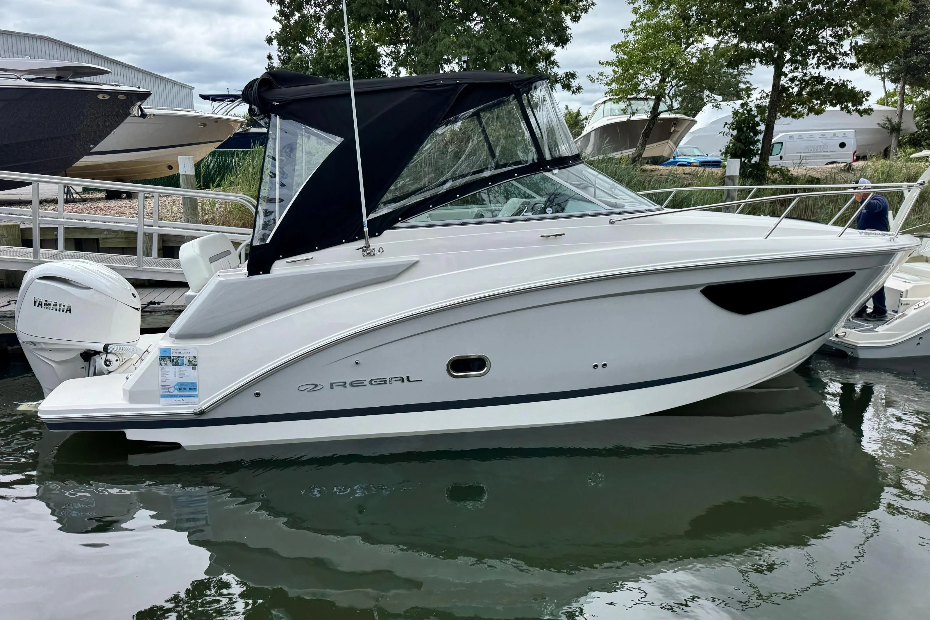 2026 Regal 26 XO boat docked, featuring sleek design and Yamaha outboard motor.