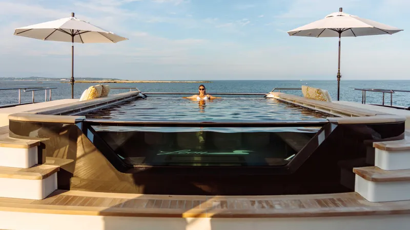 Loon Yacht Photos Pics Luxurious pool on Icon Full Displacement Motoryacht, 2010 model, with ocean view and umbrellas.