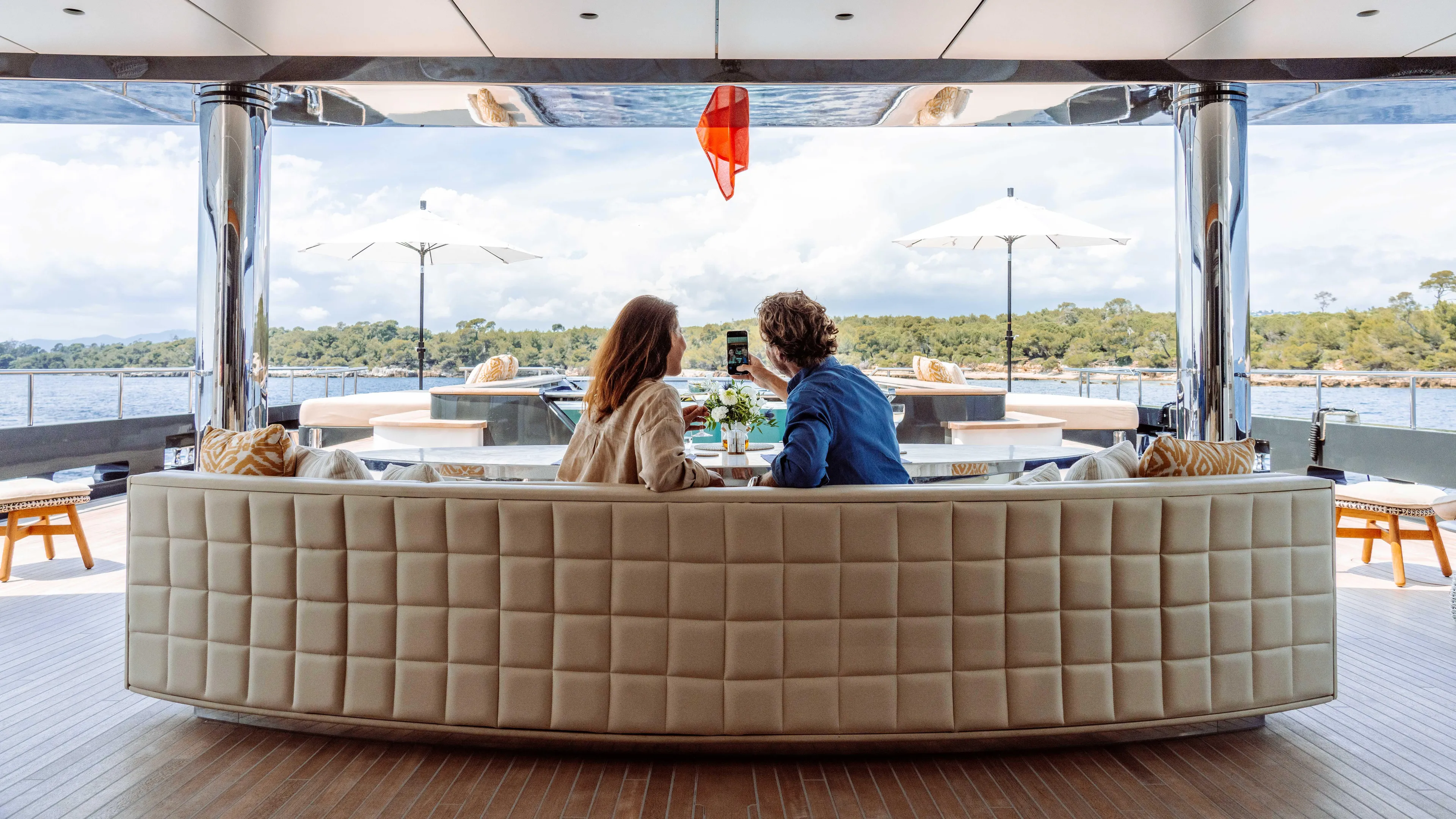 Loon Yacht Photos Pics Couple relaxing on Icon Full Displacement Motoryacht, 2010, enjoying scenic water view.