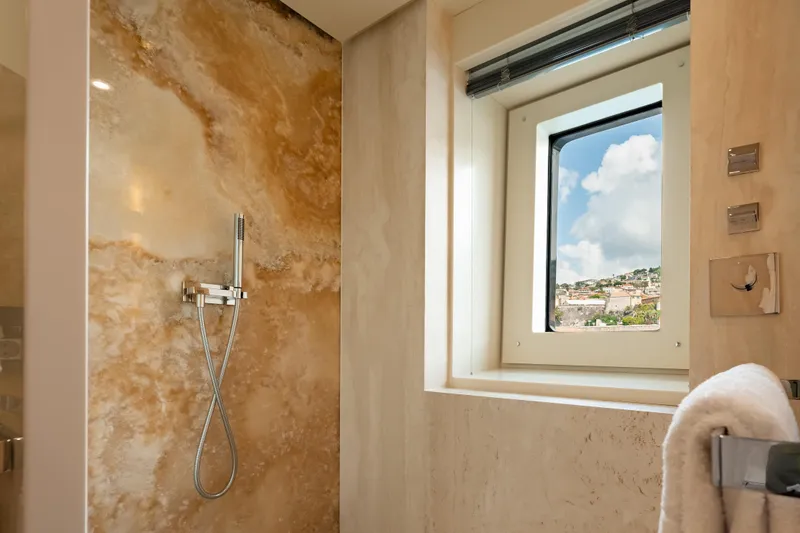 Loon Yacht Photos Pics Luxurious bathroom in 2010 Icon Full Displacement Motoryacht with marble walls and scenic window.