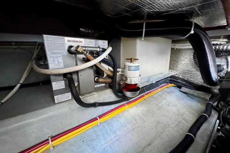 Tui Yacht Photos Pics Engine compartment of a 2005 Back Cove 29 boat, featuring wiring and plumbing components.