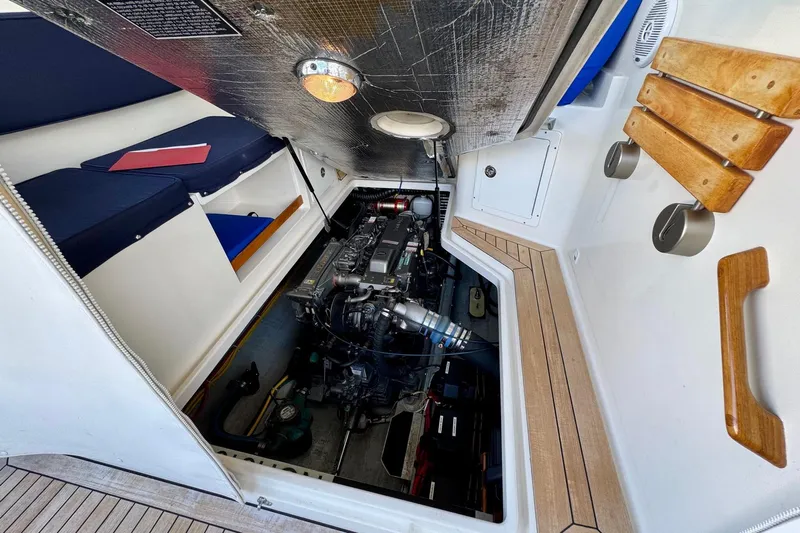Tui Yacht Photos Pics 2005 Back Cove 29 boat engine compartment with seating and wooden accents.
