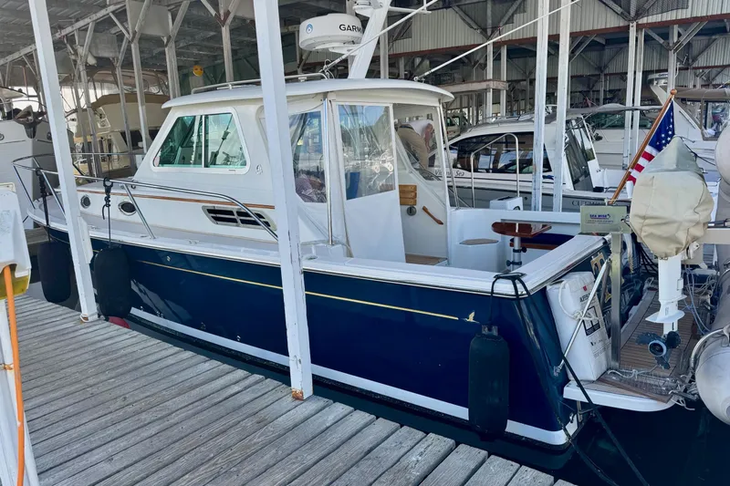 Tui Yacht Photos Pics 2005 Back Cove 29 boat docked in a marina, featuring a sleek blue hull.